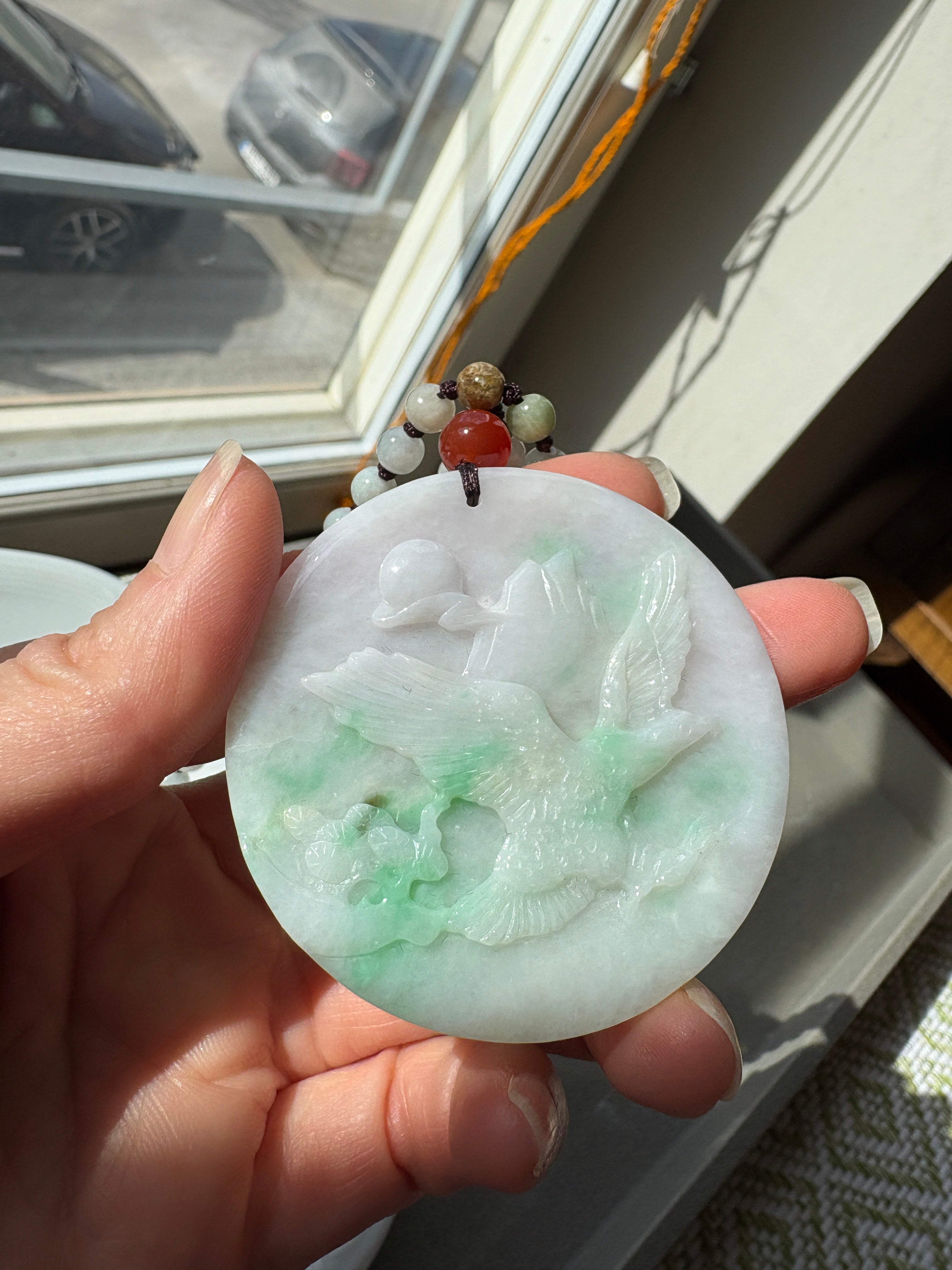 Jade necklace with carved pendant